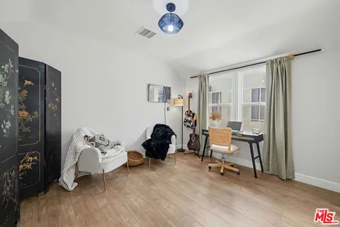 a living room with furniture a rug and a window