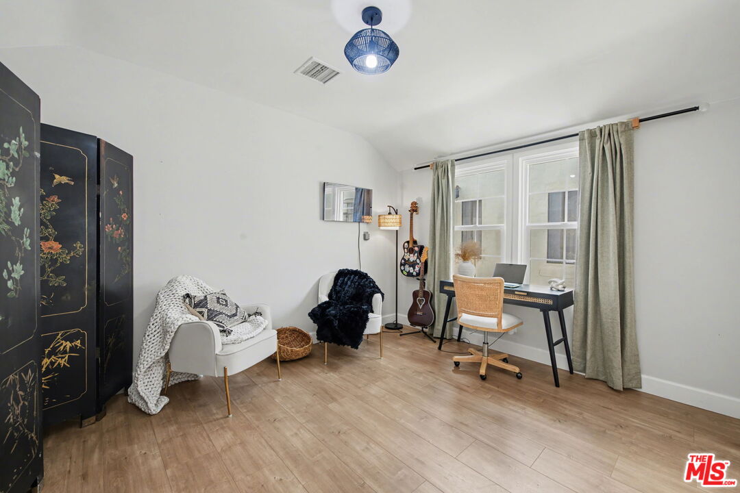 1135 West 81st Place Los Angeles, CA 90044 - Photo 10 of 23 a living room with furniture a rug and a window