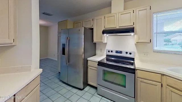 a kitchen with granite countertop cabinets and steel stainless steel appliances
