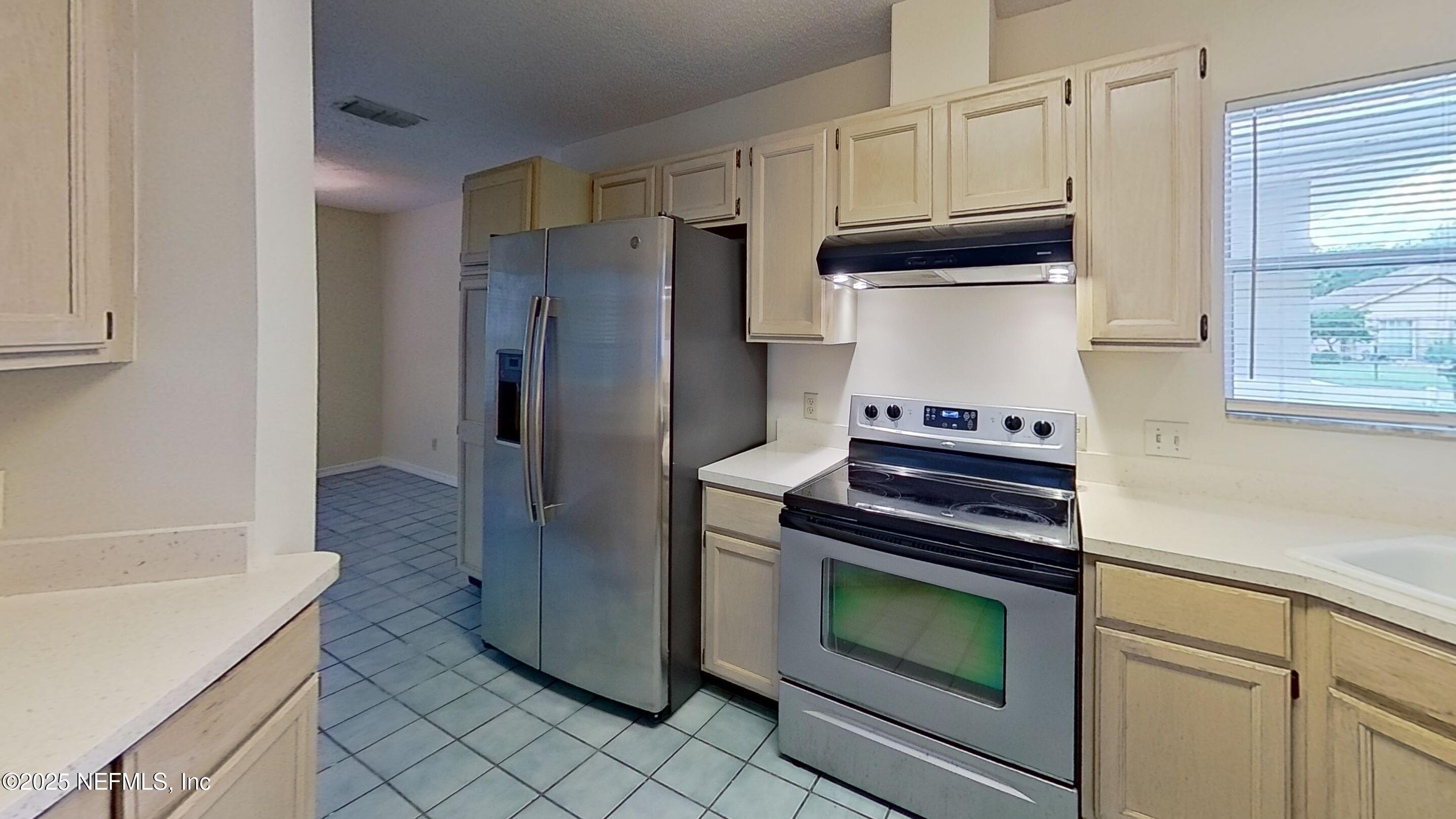 1488 Marsh Rabbit Way Fleming Island, FL 32003 - Photo 14 of 35 a kitchen with granite countertop cabinets and steel stainless steel appliances
