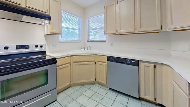 a kitchen with granite countertop cabinets stainless steel appliances and sink