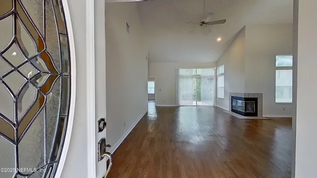 wooden floor in an empty room with a window