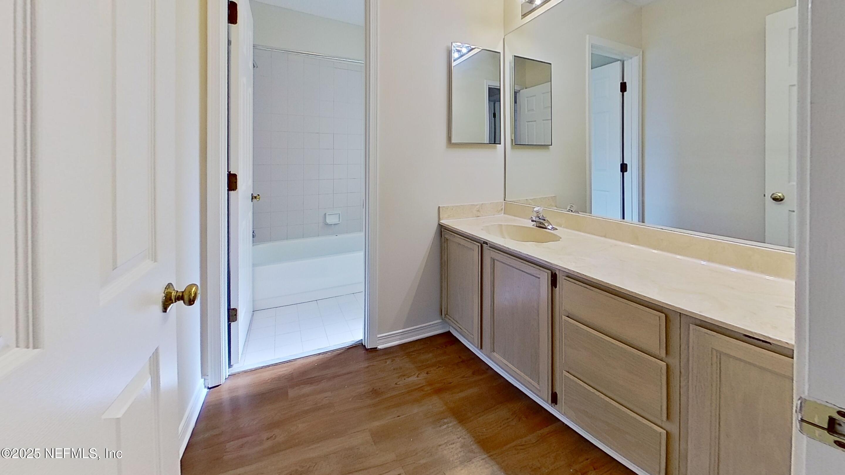 1488 Marsh Rabbit Way Fleming Island, FL 32003 - Photo 22 of 35 a bathroom with a sink and mirror