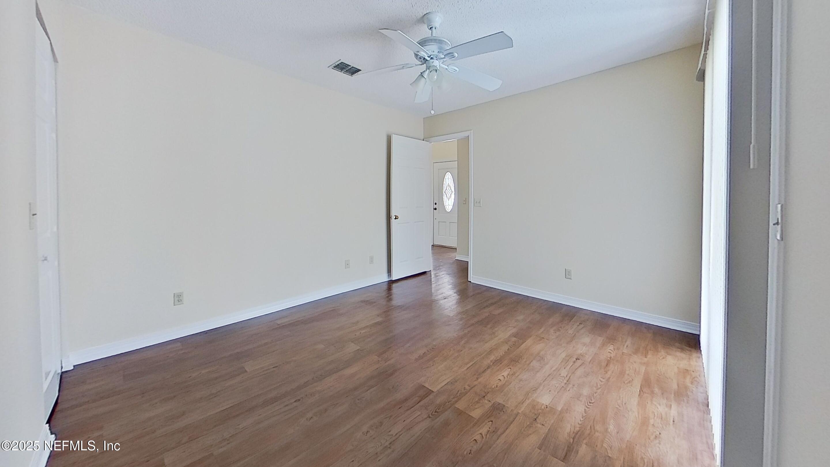 1488 Marsh Rabbit Way Fleming Island, FL 32003 - Photo 23 of 35 a view of an empty room with wooden floor