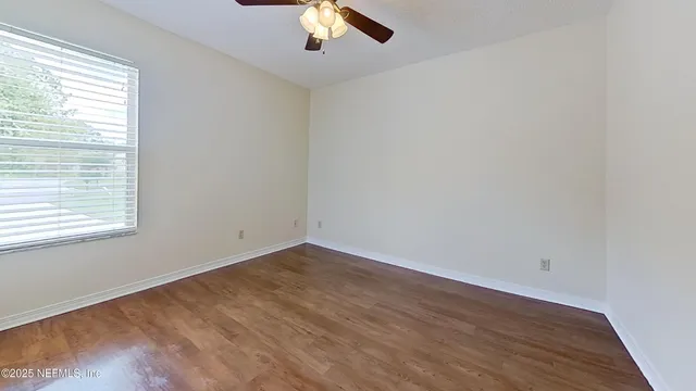 a view of a room with wooden floor