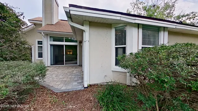 a view of a green field with lots of bushes