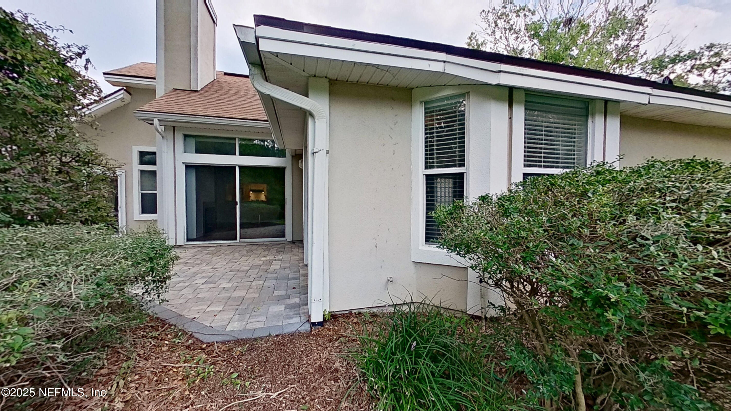 1488 Marsh Rabbit Way Fleming Island, FL 32003 - Photo 30 of 35 a view of a house with plants and a lawn chair