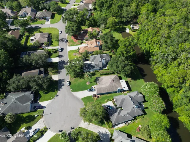 an aerial view of a house with a yard