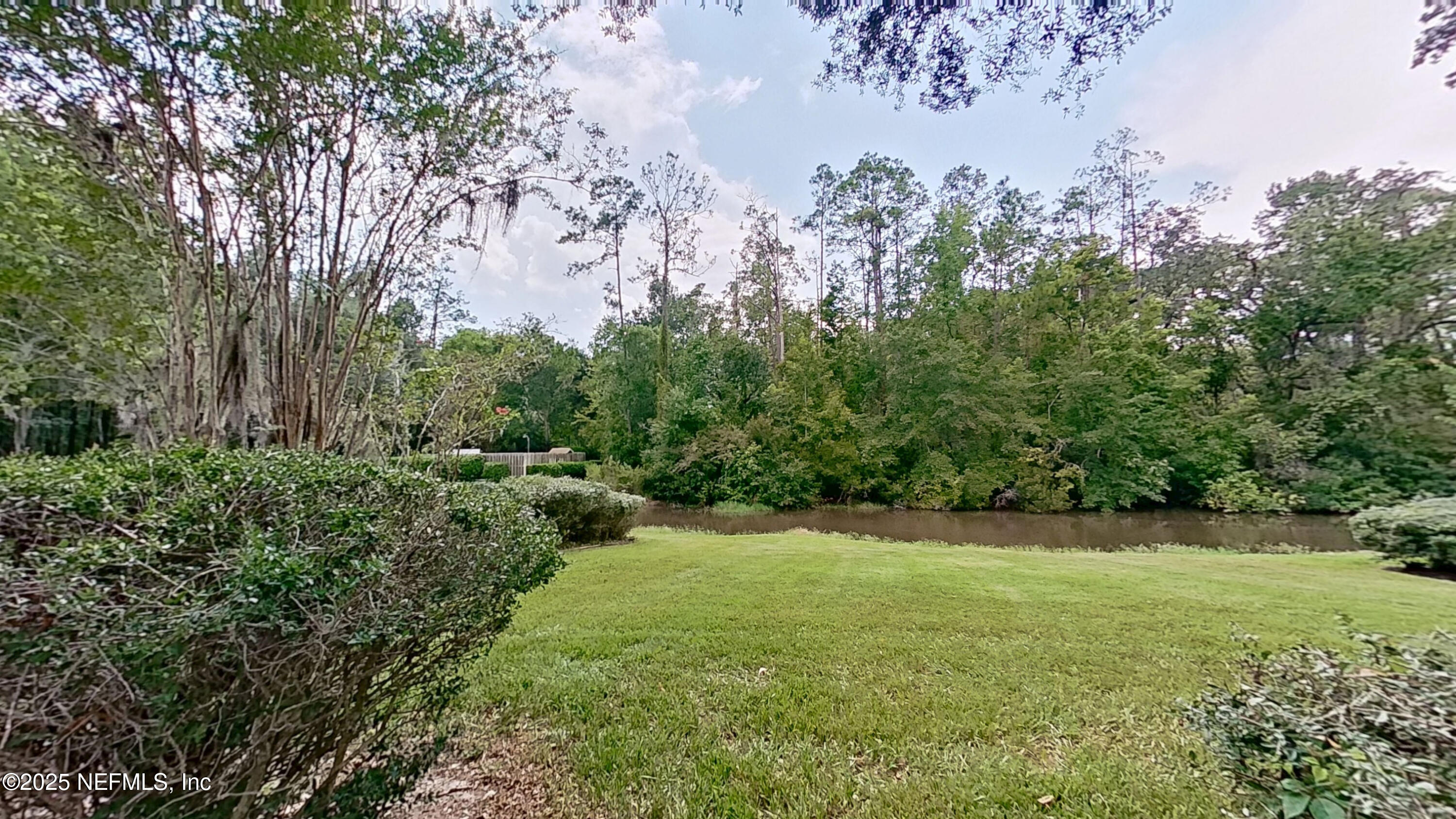 1488 Marsh Rabbit Way Fleming Island, FL 32003 - Photo 31 of 35 a view of a green field with lots of bushes