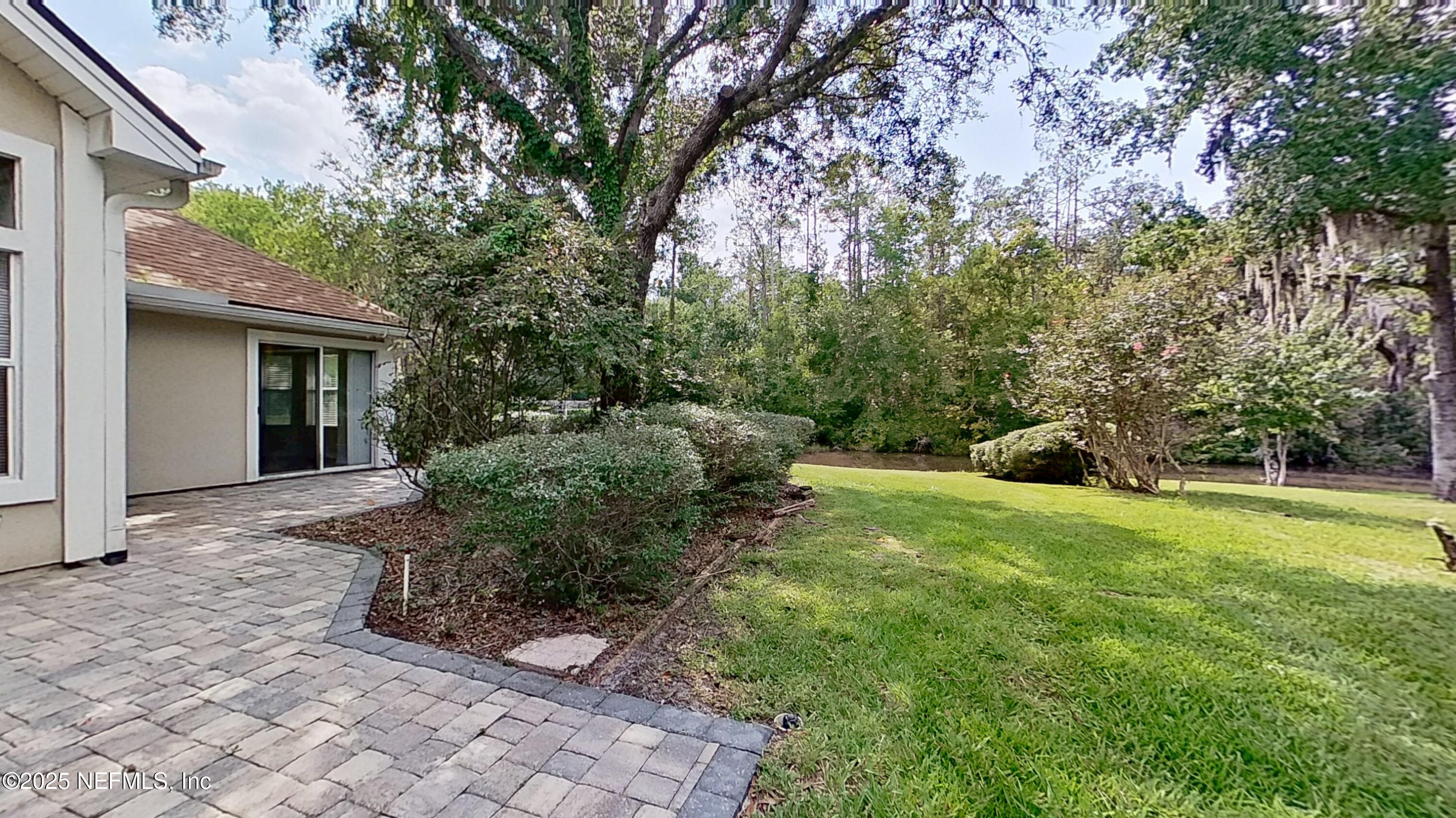 1488 Marsh Rabbit Way Fleming Island, FL 32003 - Photo 32 of 35 a view of a backyard with large trees