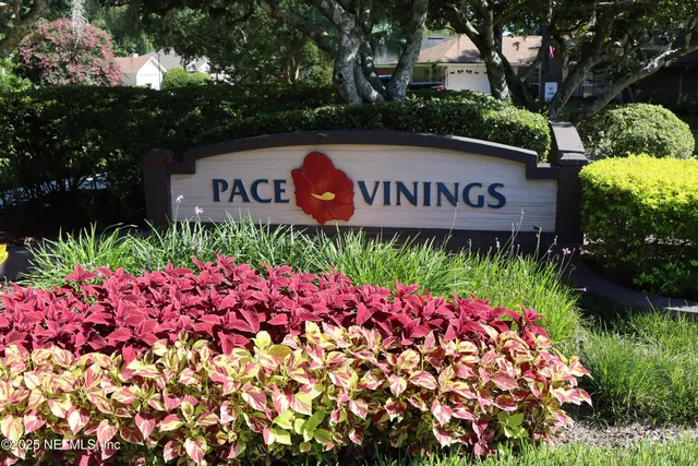 a street sign that is sitting in front of flowers
