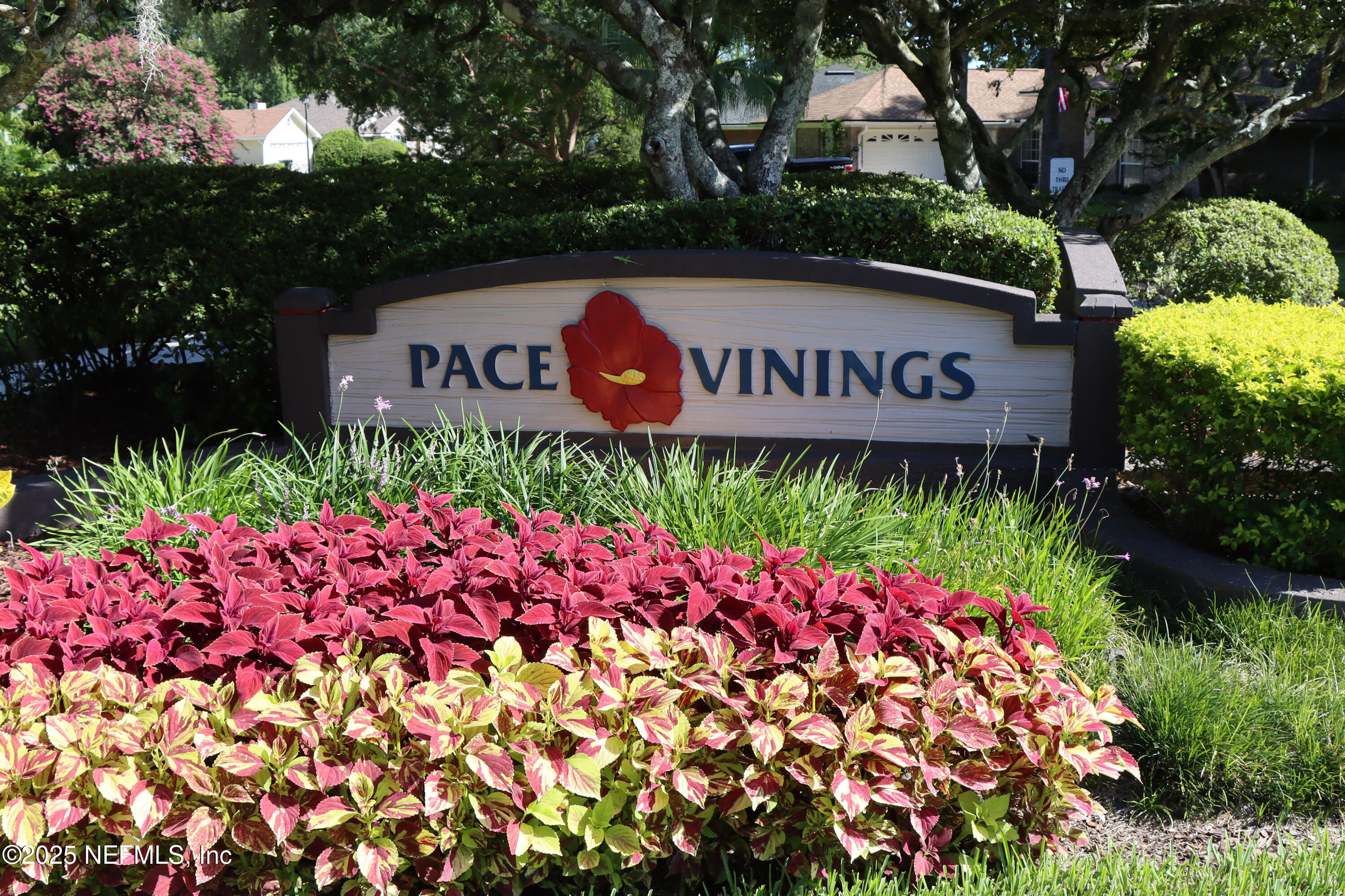 1488 Marsh Rabbit Way Fleming Island, FL 32003 - Photo 5 of 35 a street sign that is sitting in front of flowers