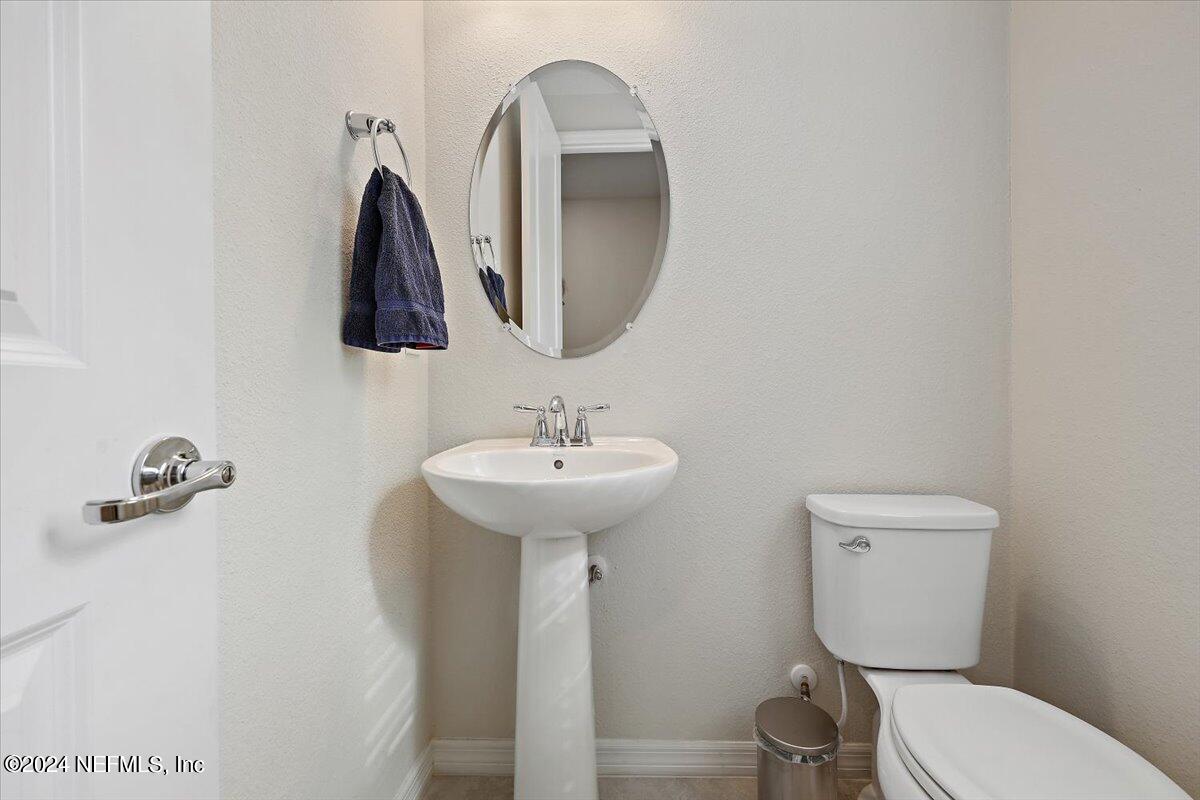 103 Spring Tide Way Ponte Vedra, FL 32081 - Photo 15 of 26 a bathroom with a toilet sink and mirror