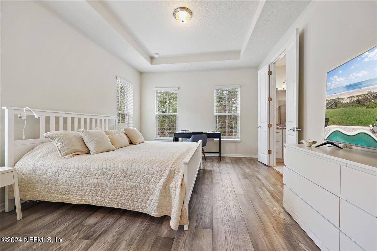 103 Spring Tide Way Ponte Vedra, FL 32081 - Photo 16 of 26 a bedroom with a bed and large windows