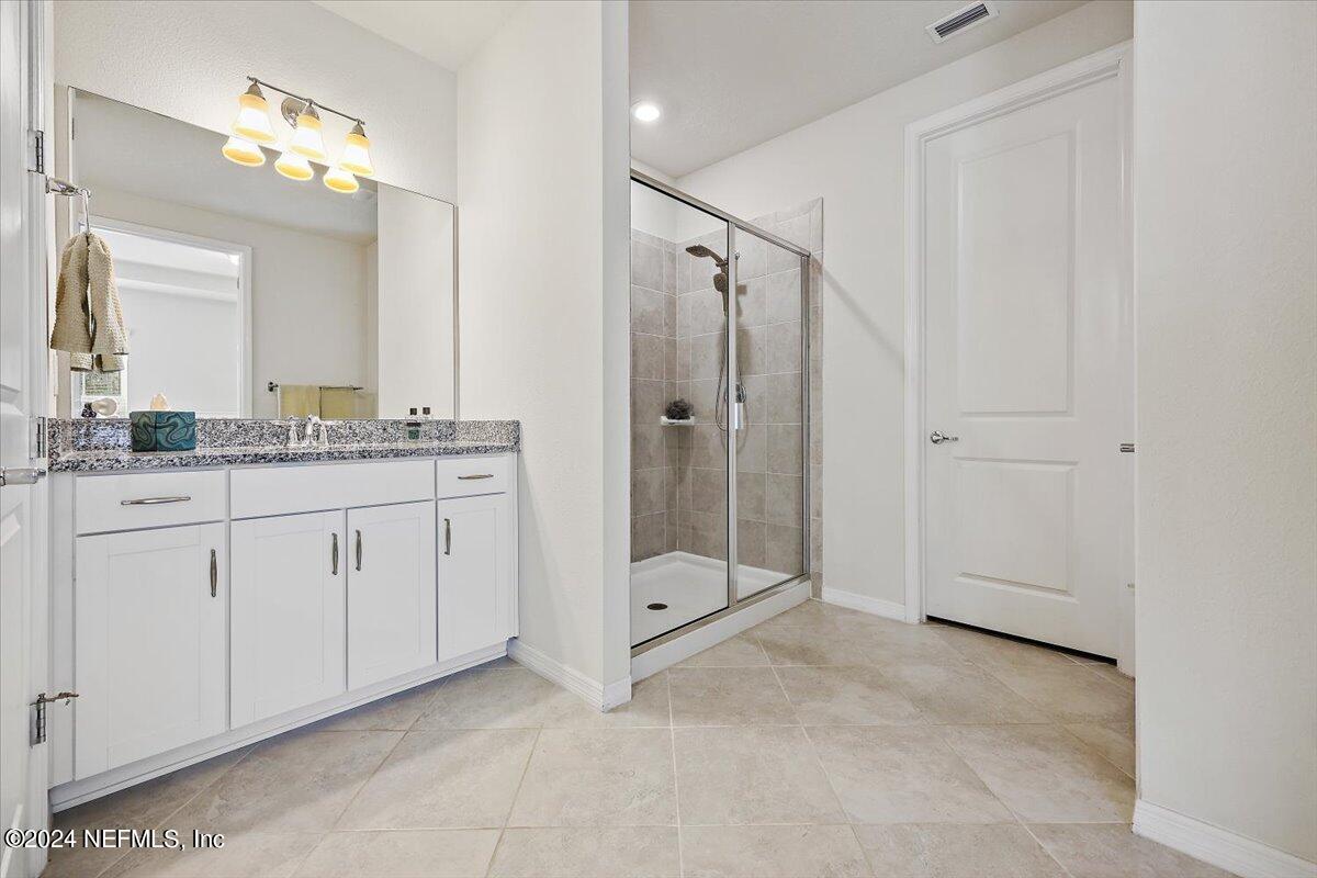 103 Spring Tide Way Ponte Vedra, FL 32081 - Photo 18 of 26 a bathroom with a granite countertop sink mirror and