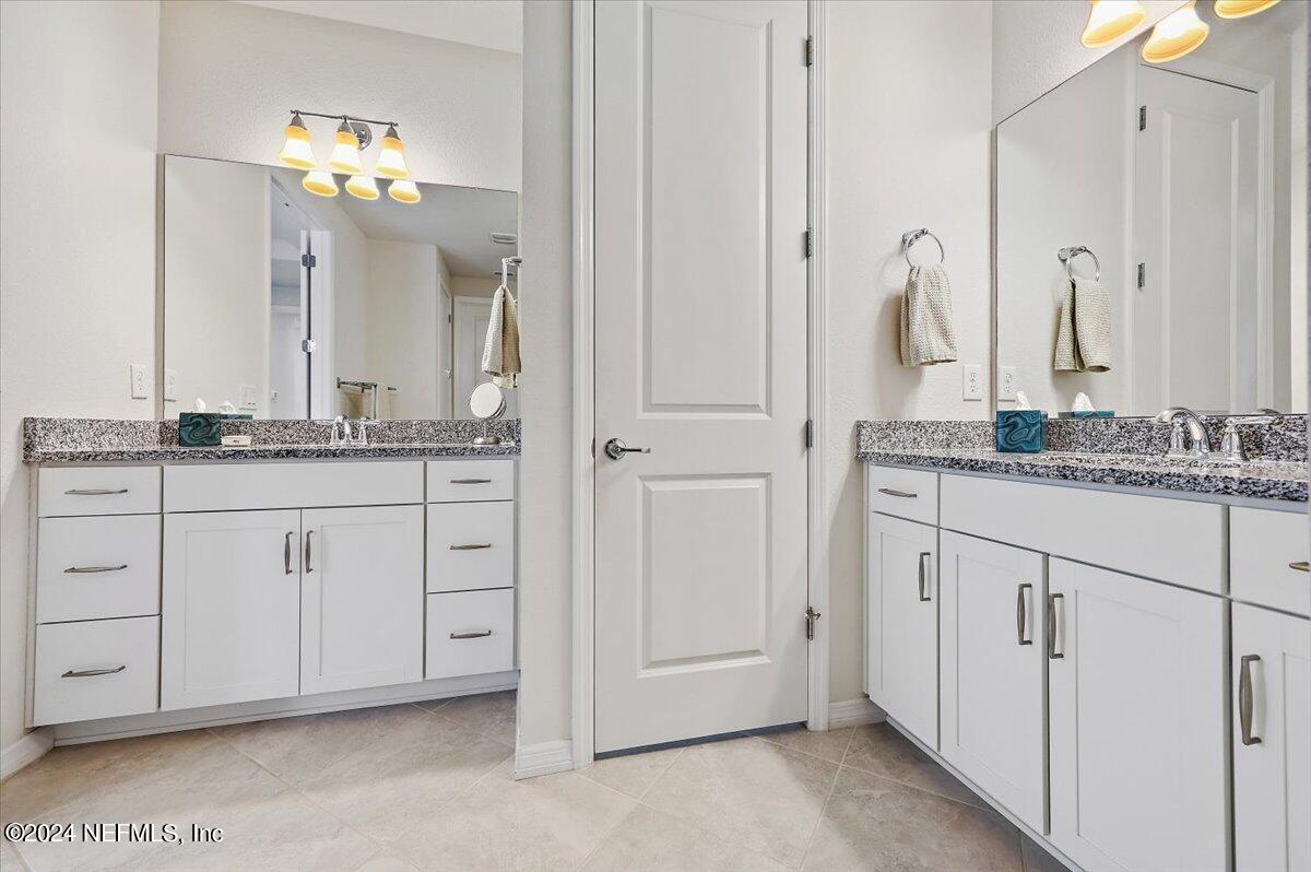 103 Spring Tide Way Ponte Vedra, FL 32081 - Photo 19 of 26 a bathroom with a granite countertop sink and a mirror