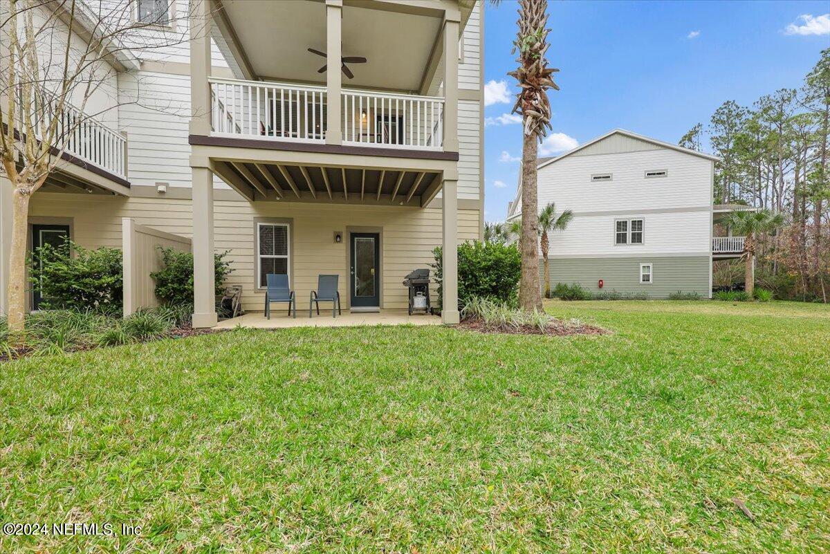 103 Spring Tide Way Ponte Vedra, FL 32081 - Photo 23 of 26 a view of a house with a yard and deck