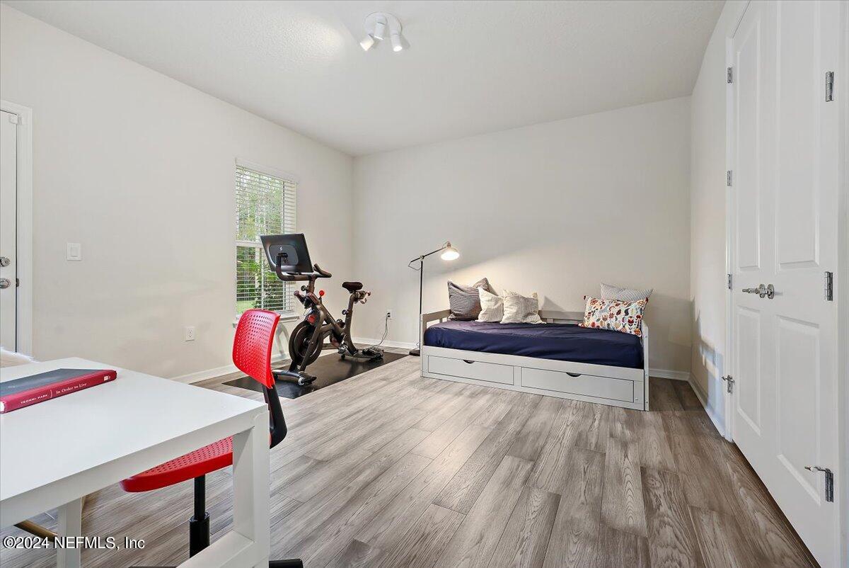 103 Spring Tide Way Ponte Vedra, FL 32081 - Photo 4 of 26 a view of a room with wooden floor and gym equipment