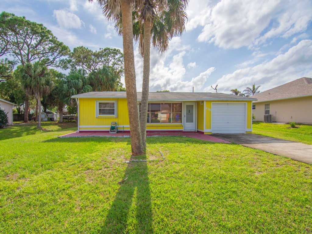 418 Maple Street Sebastian, FL 32958 - Photo 1 of 28 a view of a house with backyard and a tree
