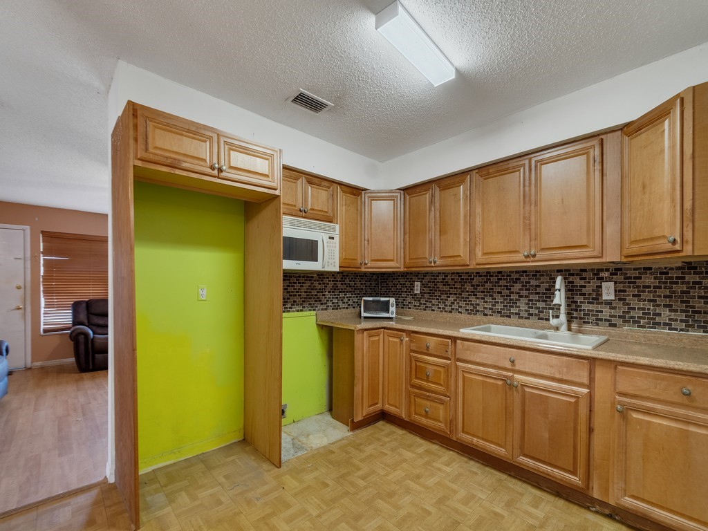 418 Maple Street Sebastian, FL 32958 - Photo 12 of 28 a kitchen with stainless steel appliances granite countertop a refrigerator a sink and dishwasher