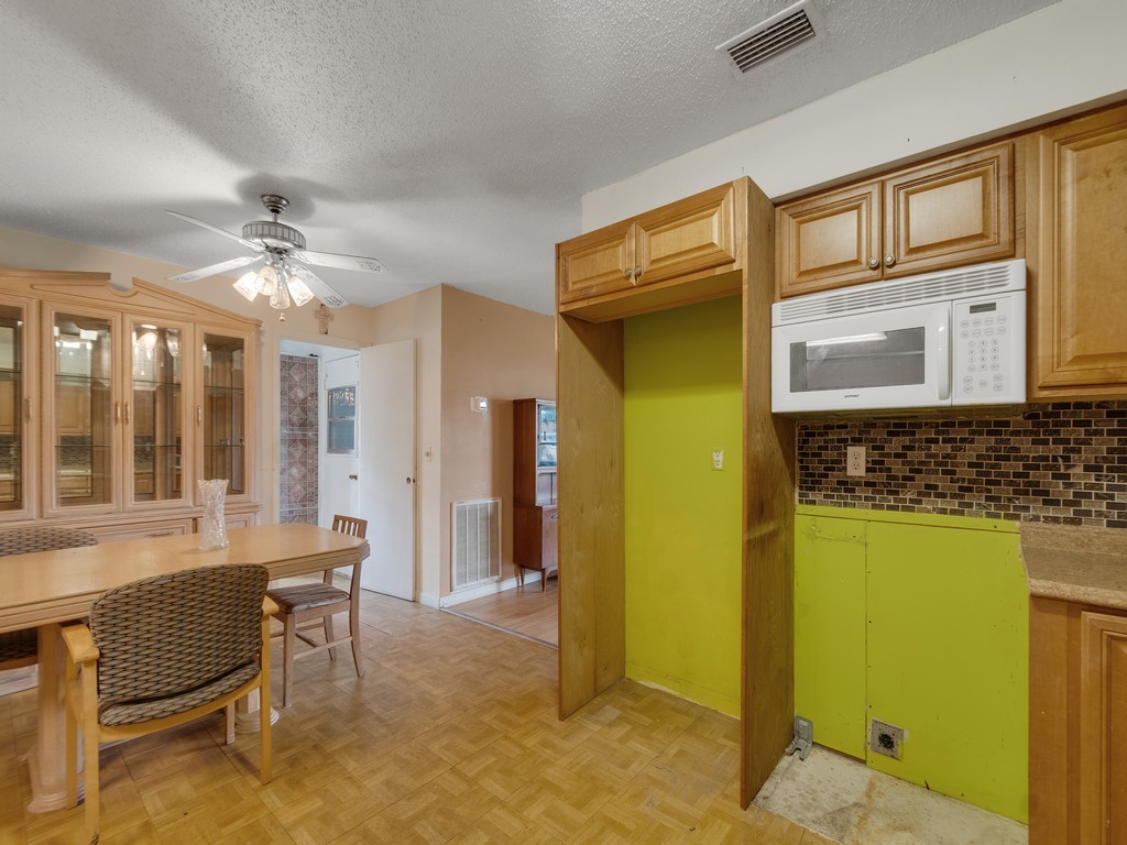 418 Maple Street Sebastian, FL 32958 - Photo 13 of 28 a living room with a table and a chandelier