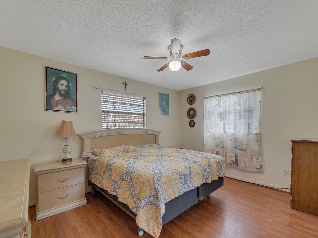 418 Maple Street Sebastian, FL 32958 - Photo 17 of 28 a bedroom with a bed and a window