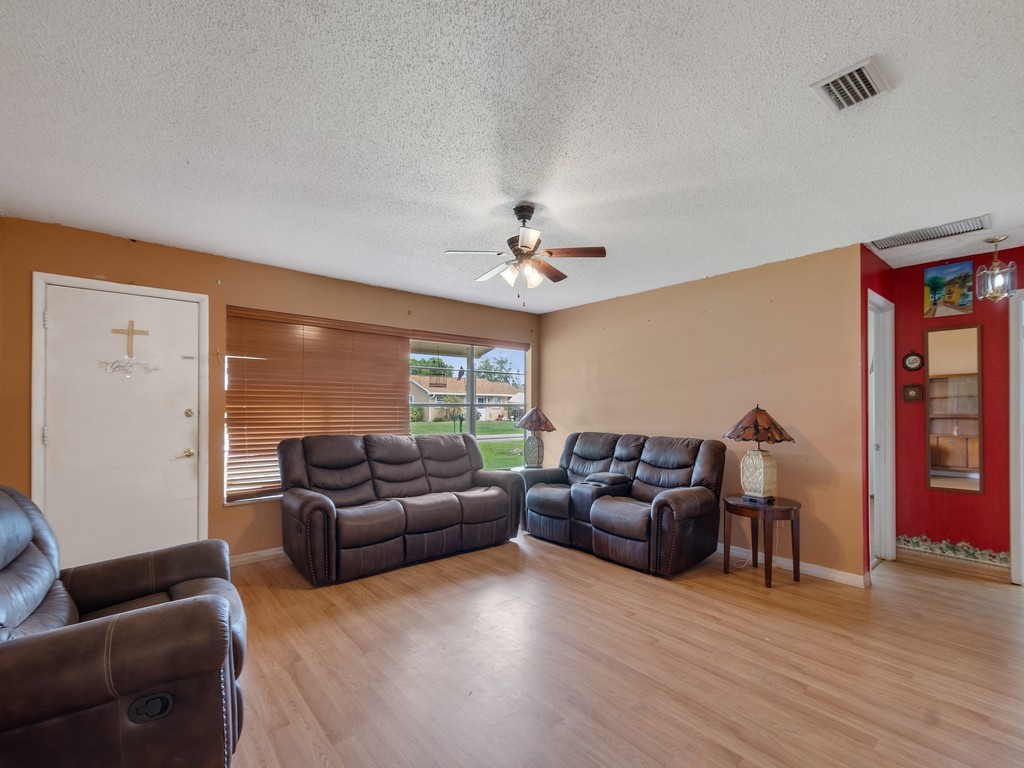 418 Maple Street Sebastian, FL 32958 - Photo 7 of 28 a living room with furniture and a large window