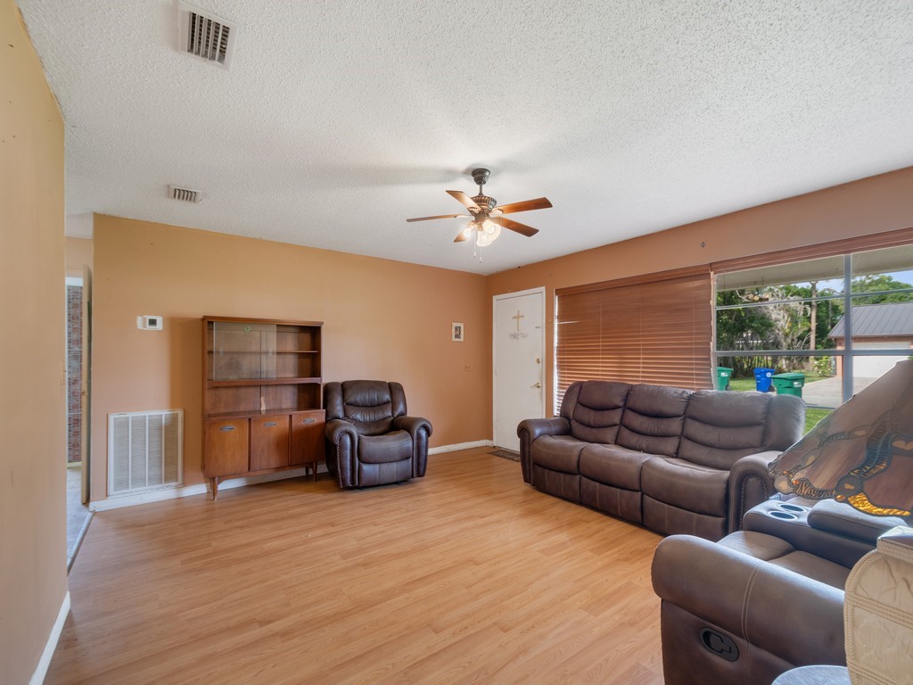 418 Maple Street Sebastian, FL 32958 - Photo 8 of 28 a living room with furniture and a large window