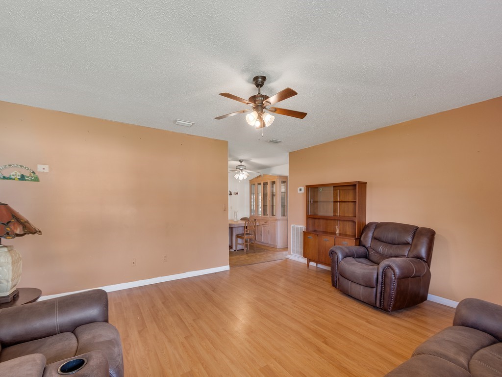 418 Maple Street Sebastian, FL 32958 - Photo 9 of 28 a living room with furniture and a ceiling fan