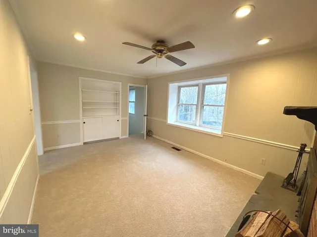a view of an empty room with a fireplace