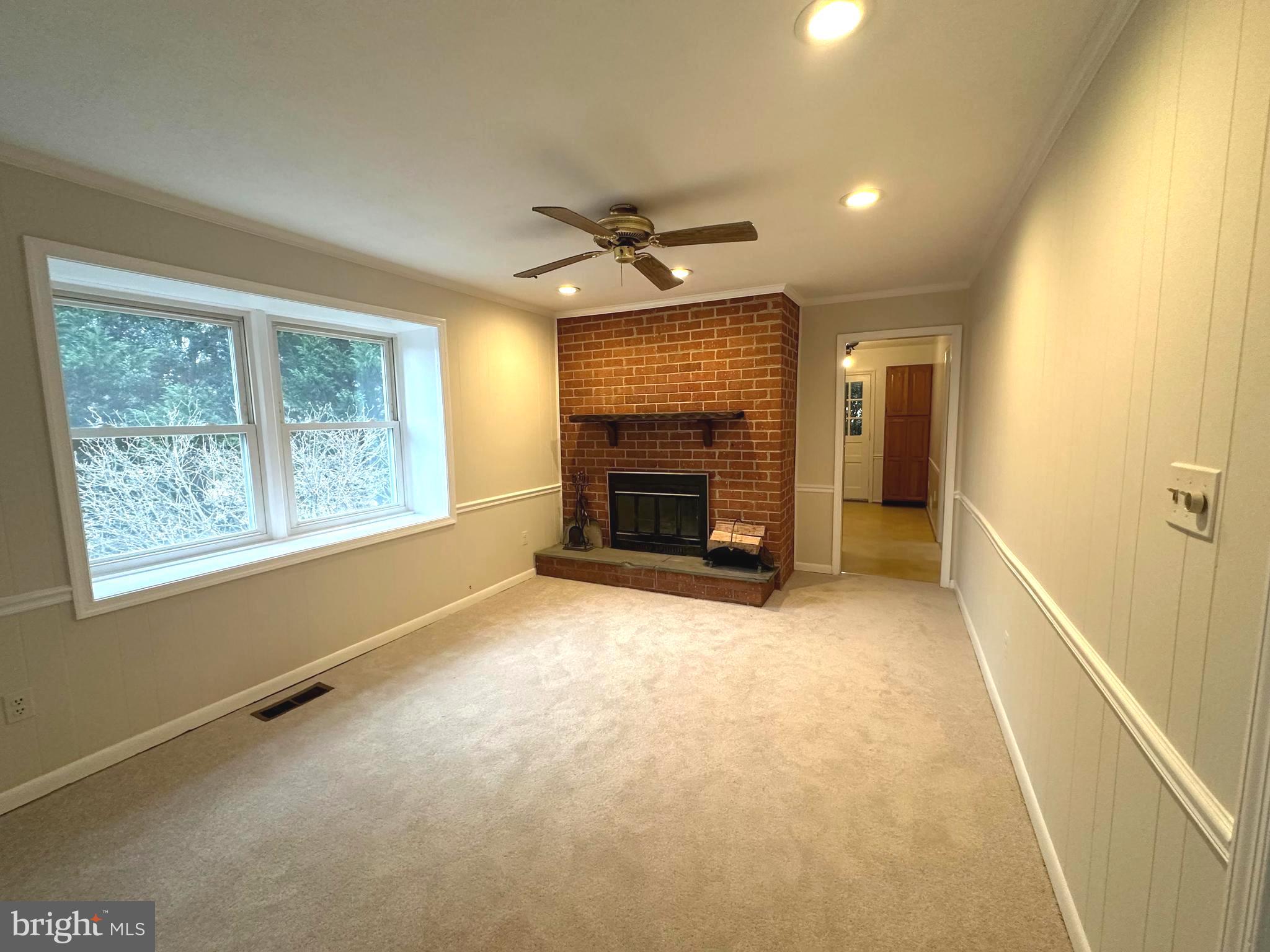 4037 Olney Laytonsville Road Olney, MD 20832 - Photo 16 of 42 a view of an empty room with a fireplace