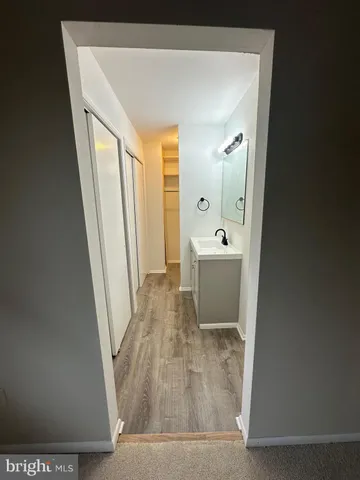 an empty room with closet and windows