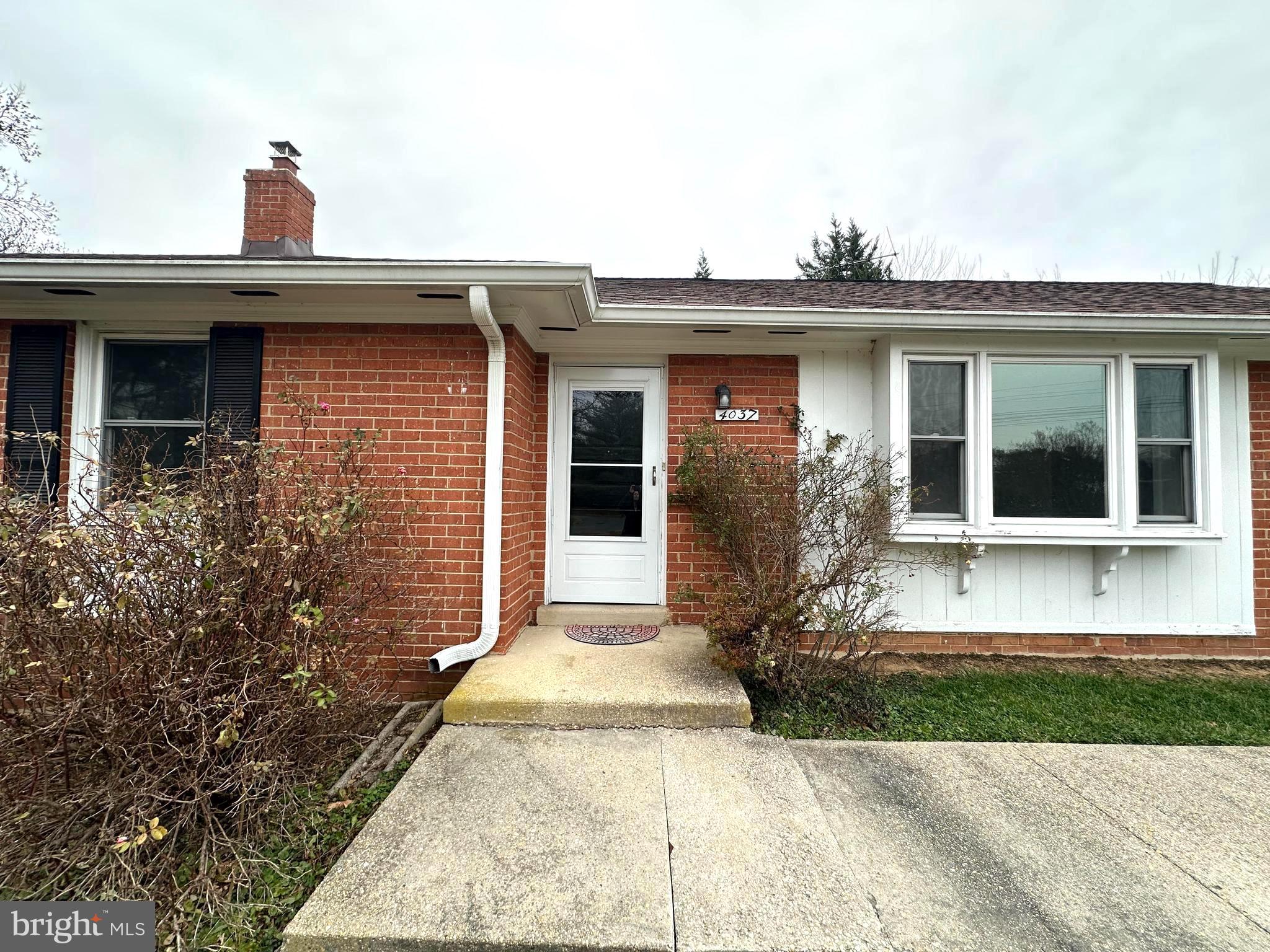 4037 Olney Laytonsville Road Olney, MD 20832 - Photo 4 of 42 a view of a house with a small yard and plants