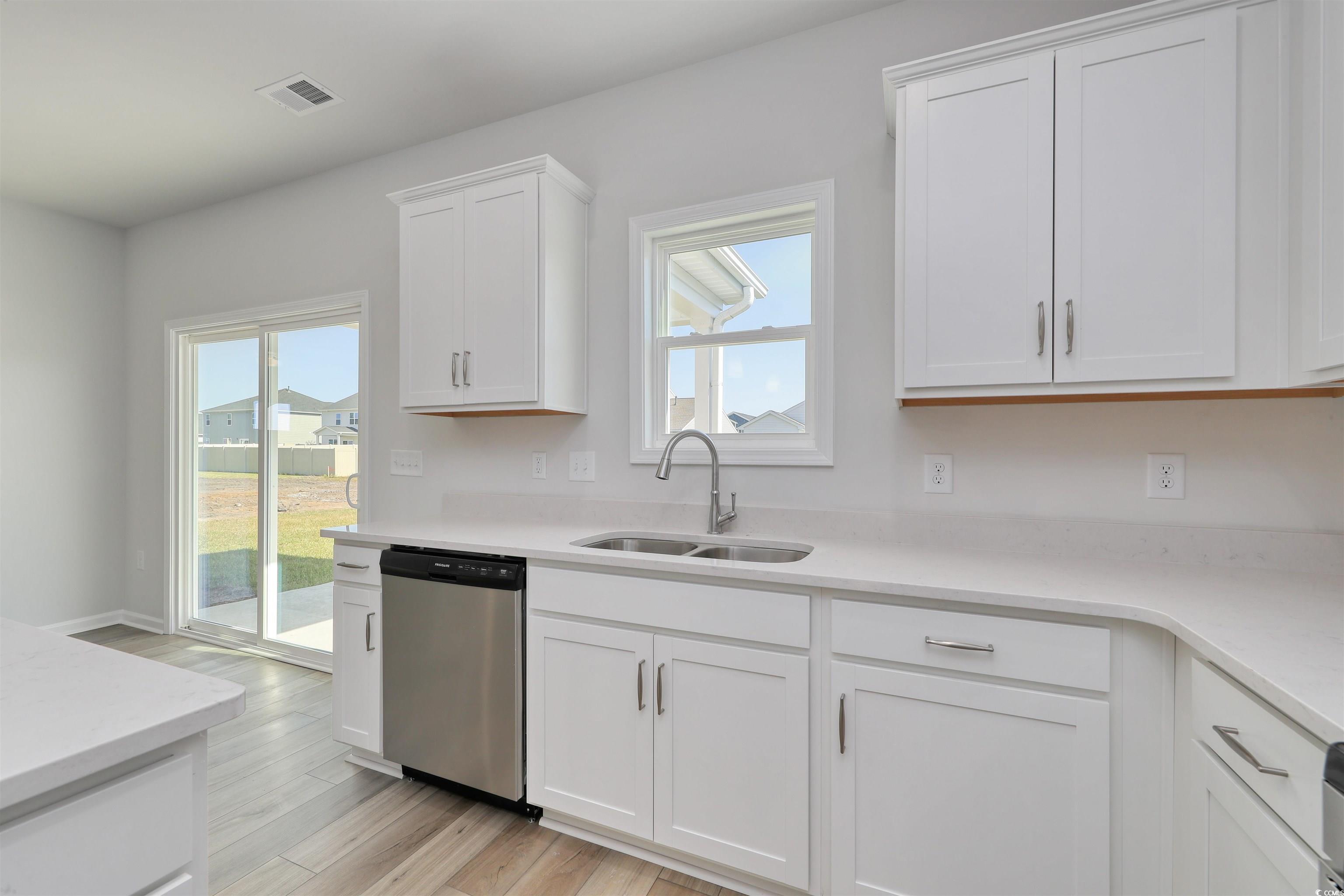 720 St Albans Loop Conway, SC 29526 - Photo 11 of 15 Kitchen with white cabinetry, dishwasher, a health