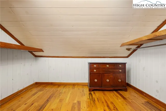 a bedroom with bed and large windows