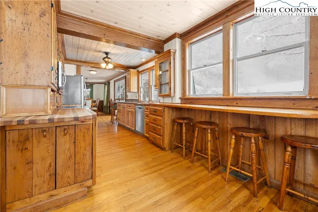 a view of a kitchen with wooden floor and furniture