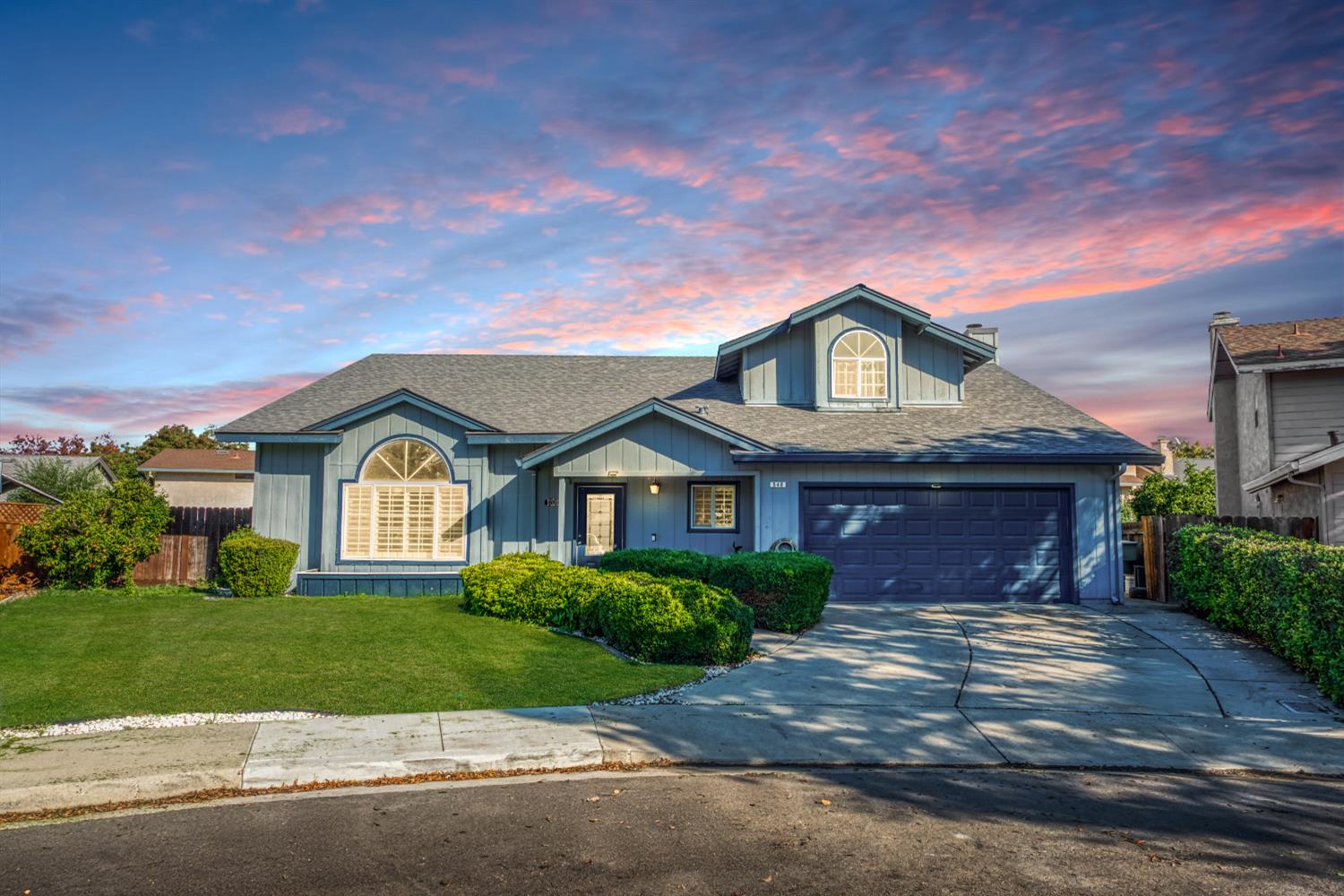 a front view of a house with a garden