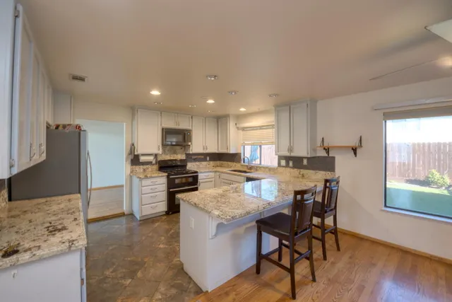 a large kitchen with a table and chairs in it