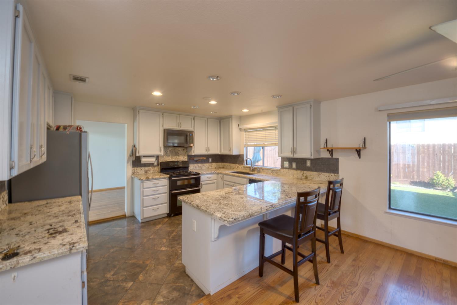 548 Hansen Court Patterson, CA 95363 - Photo 11 of 38 a large kitchen with a table and chairs in it