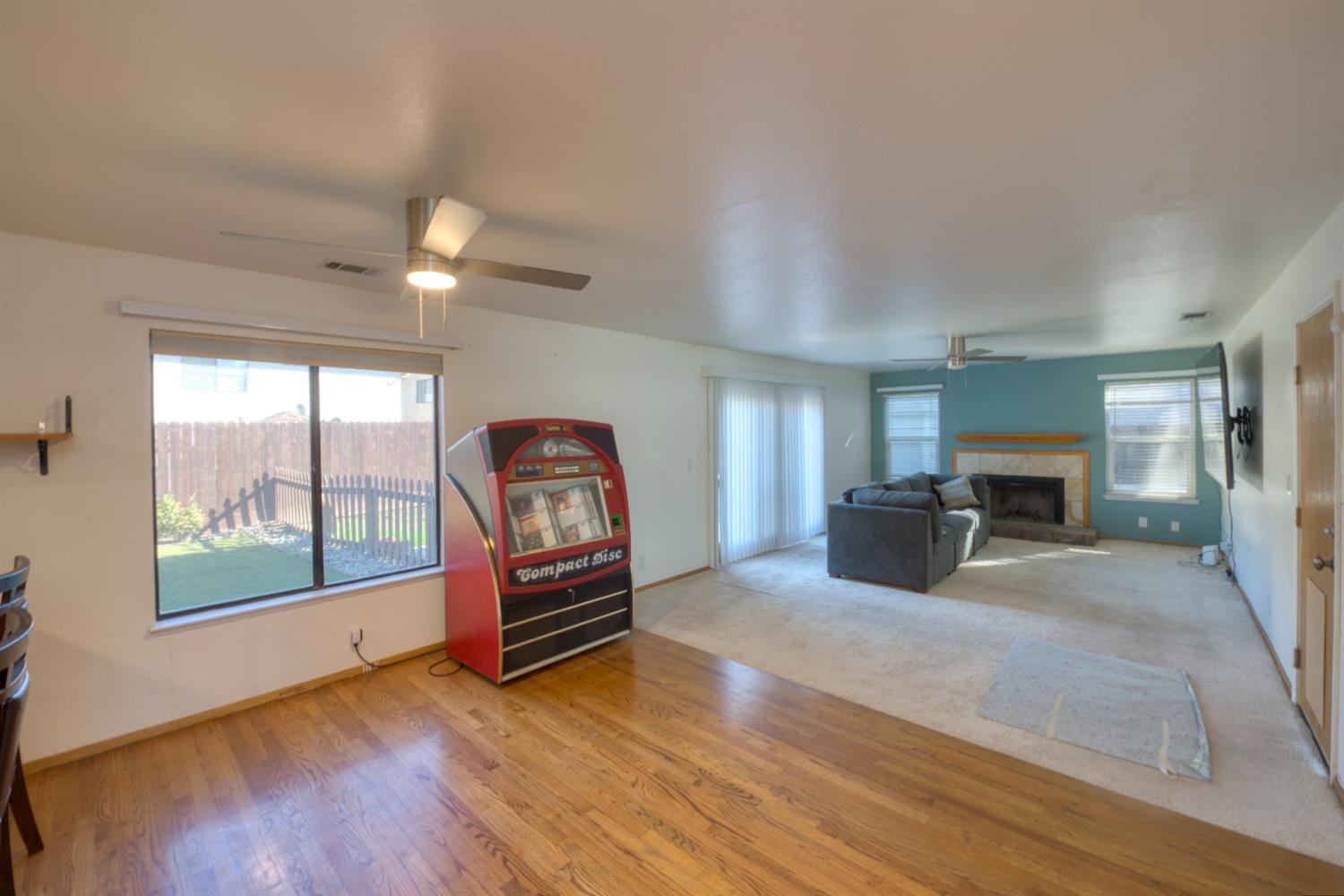 548 Hansen Court Patterson, CA 95363 - Photo 13 of 38 a living room with furniture a flat screen tv and floor to ceiling window