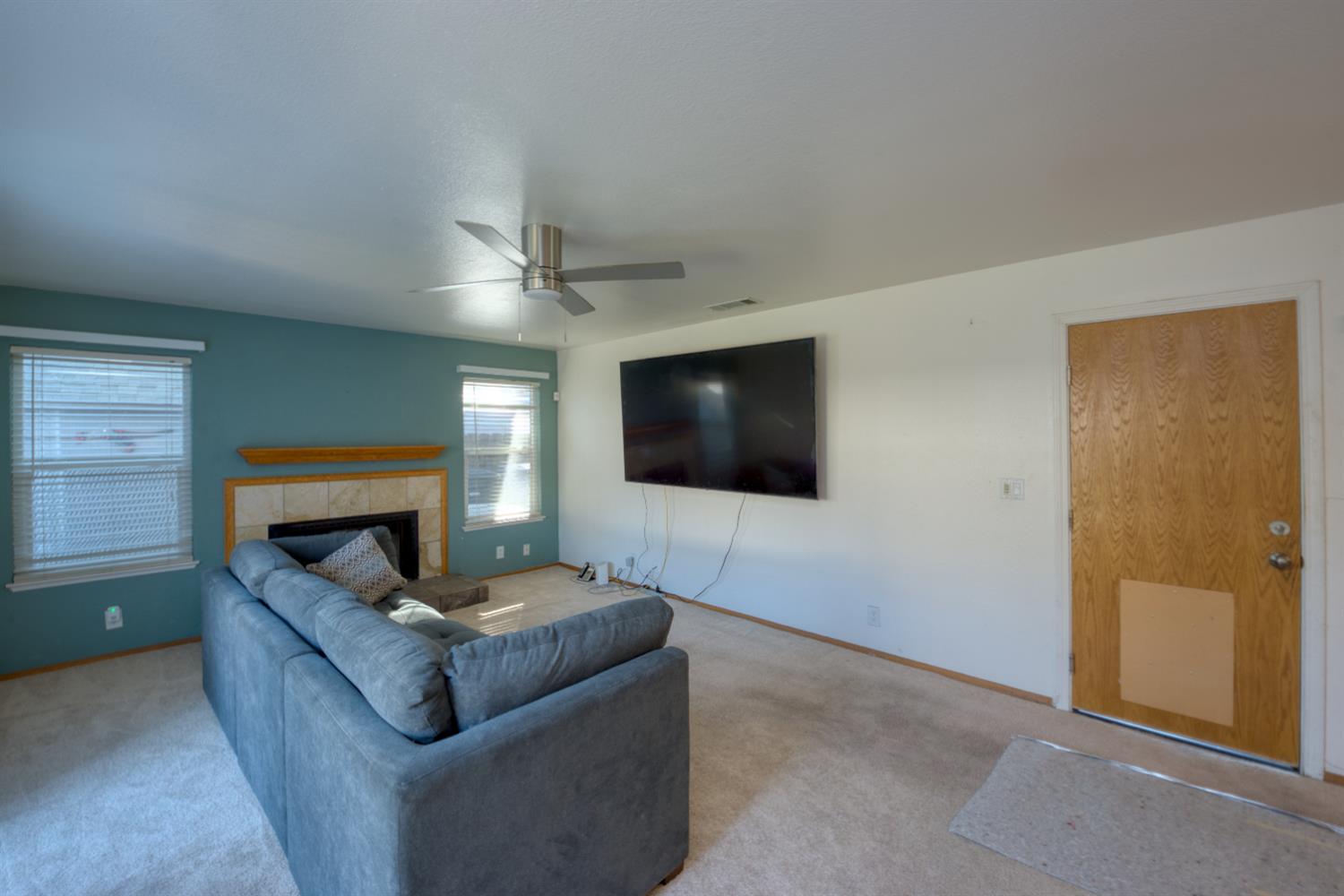 548 Hansen Court Patterson, CA 95363 - Photo 15 of 38 a living room with furniture and a flat screen tv