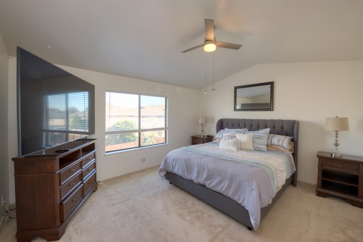 548 Hansen Court Patterson, CA 95363 - Photo 18 of 38 a bedroom with a bed next to a window