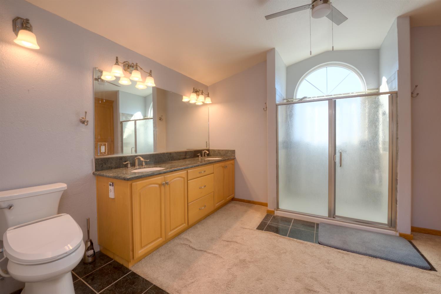548 Hansen Court Patterson, CA 95363 - Photo 20 of 38 a bathroom with a toilet sink and mirror