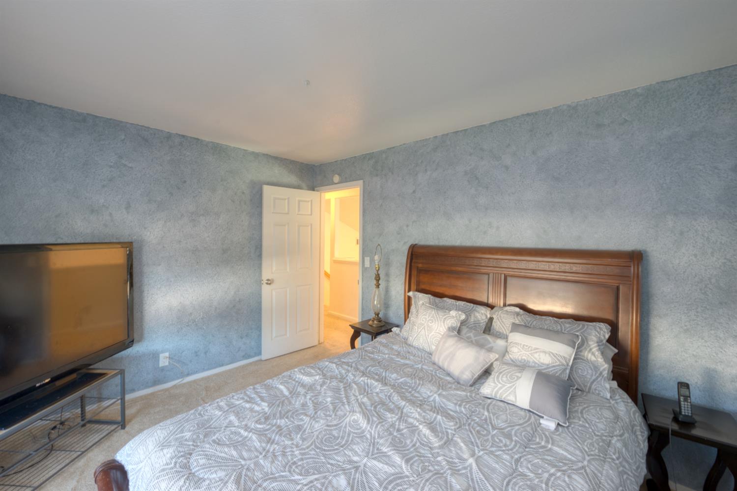 548 Hansen Court Patterson, CA 95363 - Photo 23 of 38 a bedroom with a bed and wooden floor