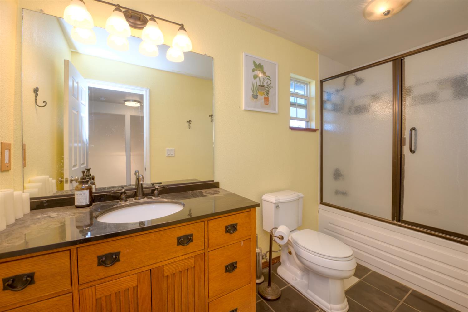 548 Hansen Court Patterson, CA 95363 - Photo 26 of 38 a bathroom with a granite countertop sink toilet and shower