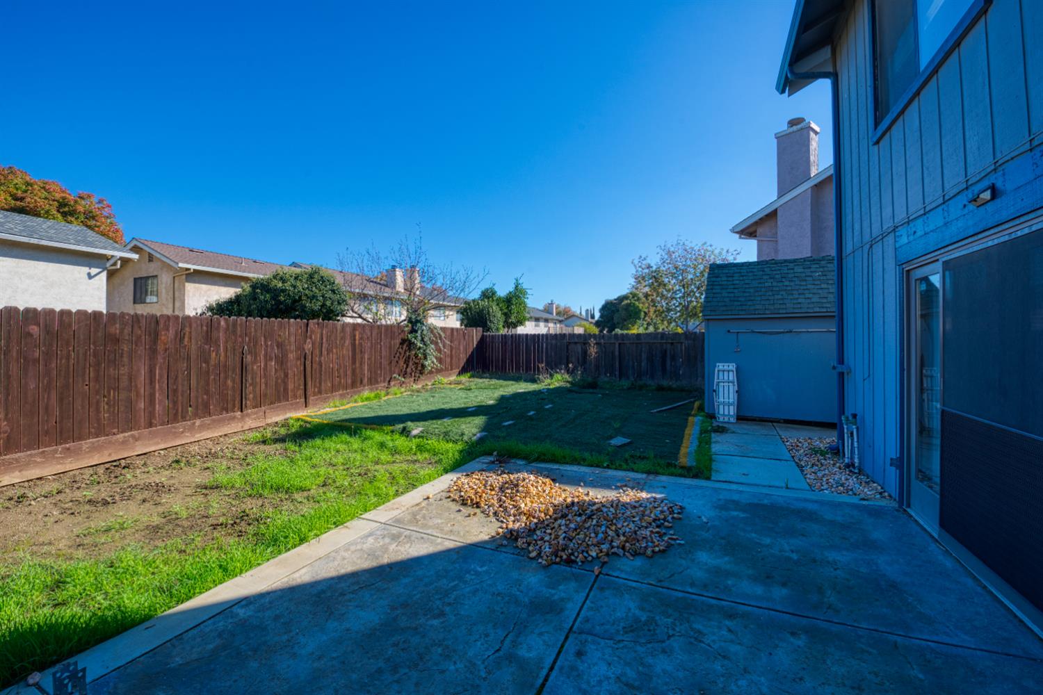 548 Hansen Court Patterson, CA 95363 - Photo 32 of 38 a view of a backyard with wooden fence