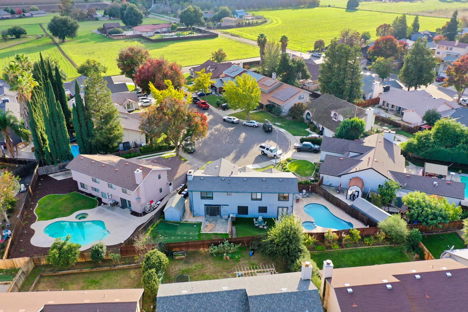 548 Hansen Court Patterson, CA 95363 - Photo 37 of 38 an aerial view of residential houses with outdoor space and swimming pool
