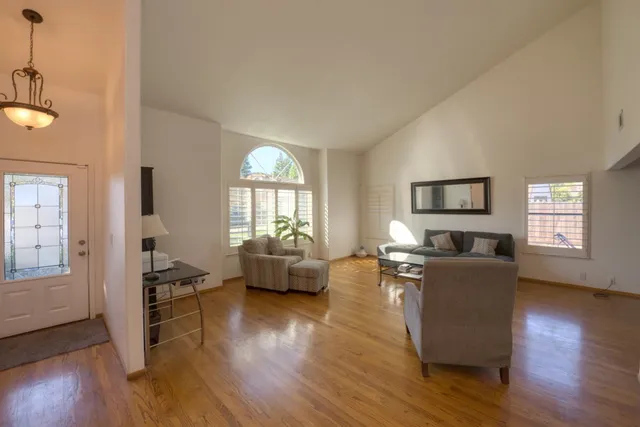 a living room with furniture and a wooden floor