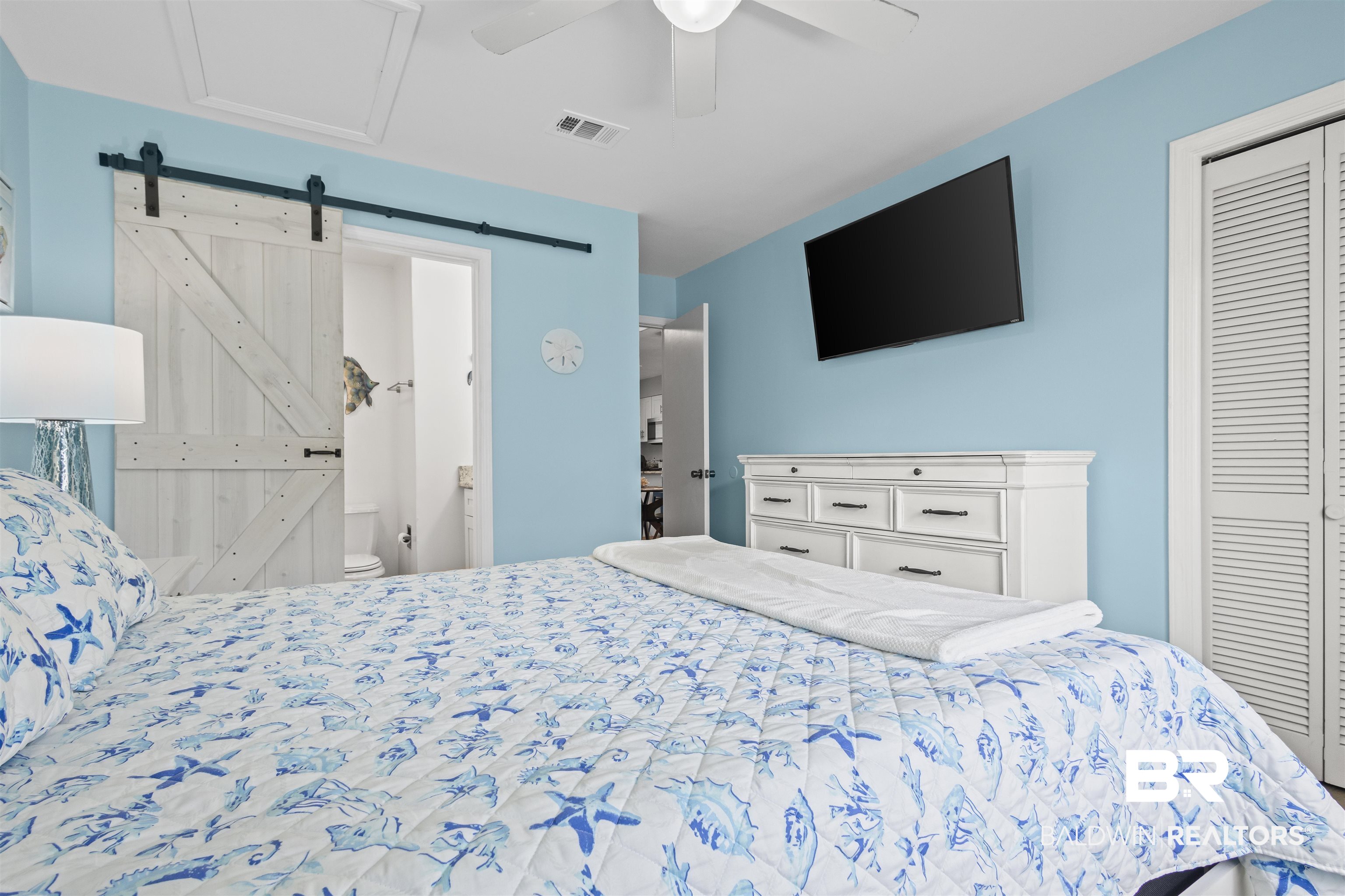 25925 Canal Road, Unit 207 Orange Beach, AL 36561 - Photo 26 of 42 Bedroom with a barn door, ceiling fan, and a closet
