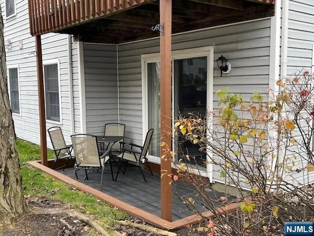 a view of a patio with table and chairs and potted plants